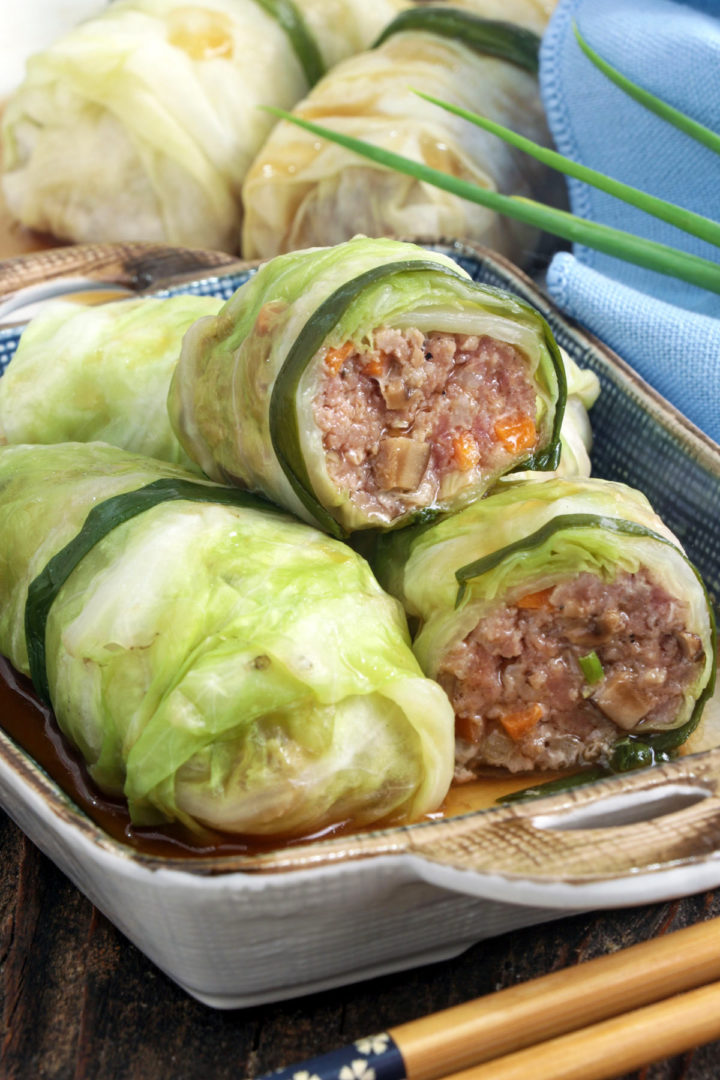Sliced Asian stuffed cabbage rolls on a plate.