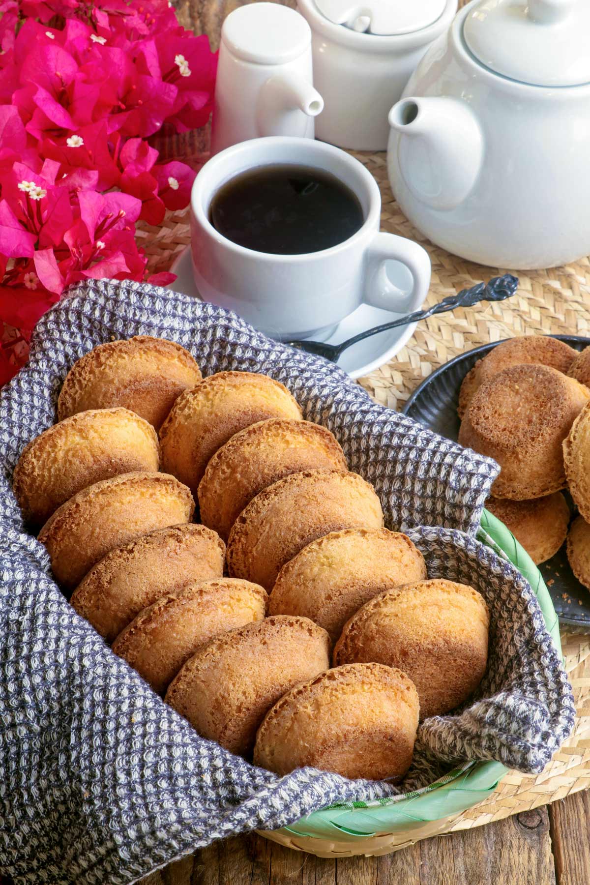 Freshly baked Mamon Tostado in a bread basket served with hot coffee.